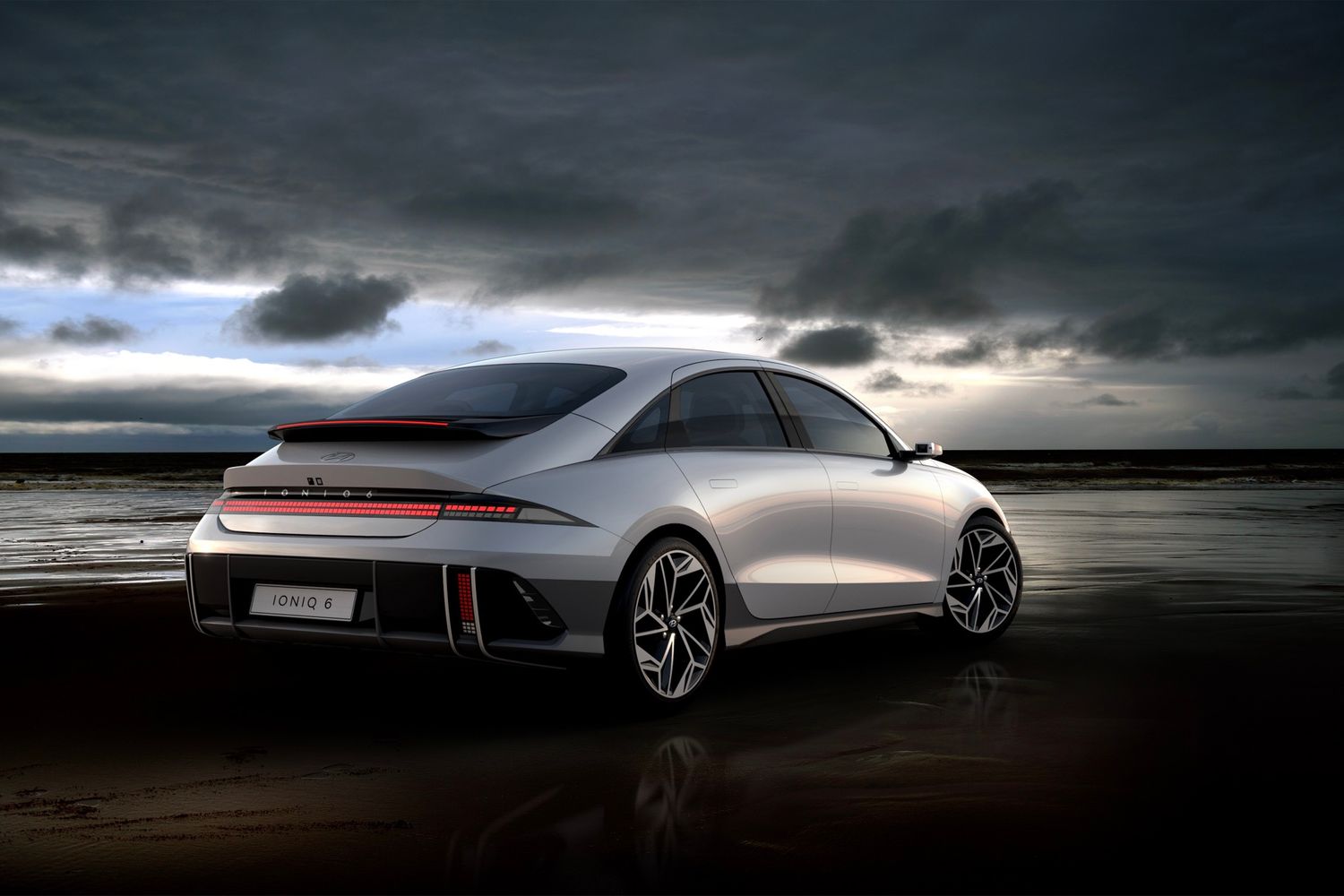 White Hyundai Ioniq 6 at beach during sunset rear view 